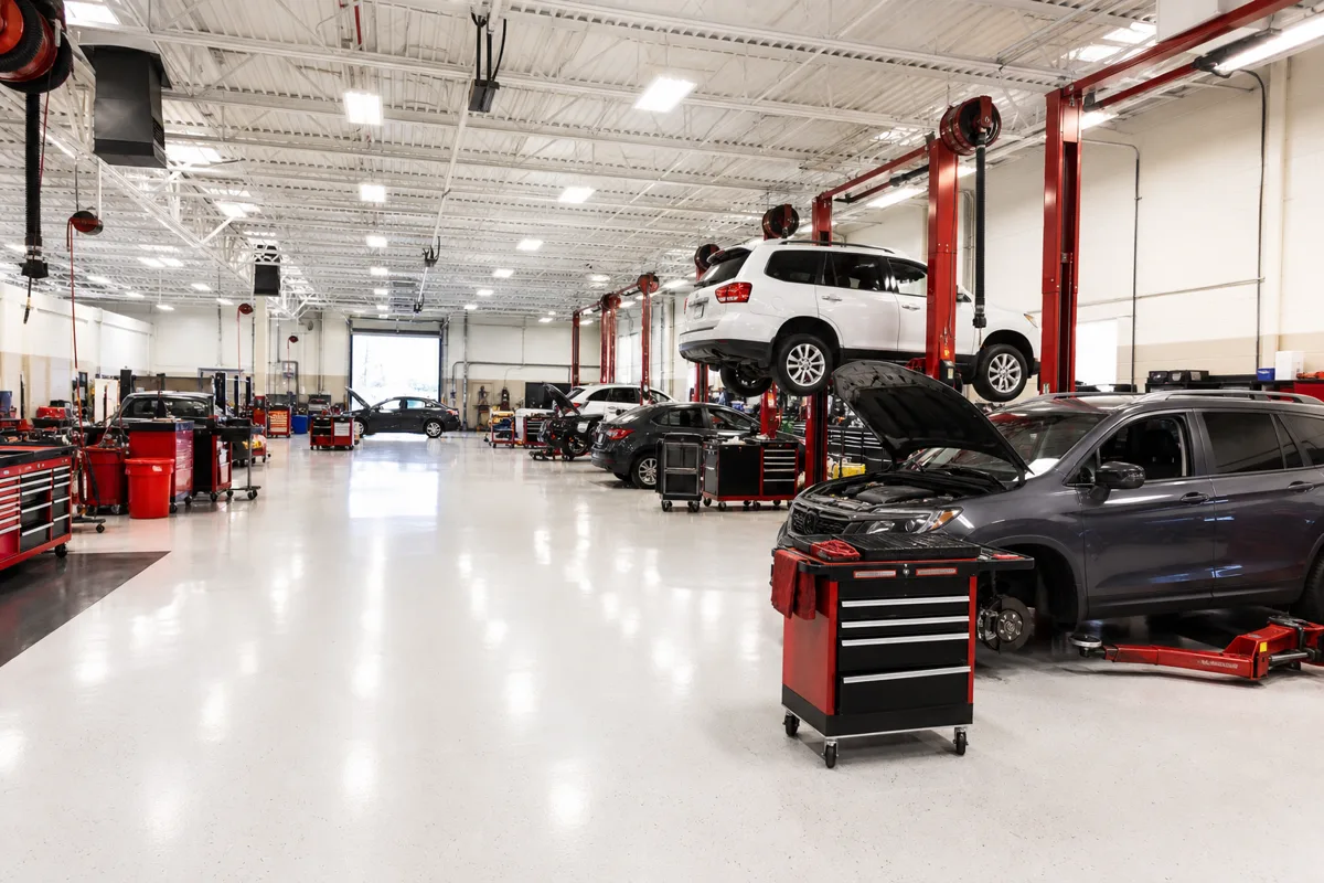 Interior service floor with vehicle lifts and organized tool stations at sclerenchym, 1200x800